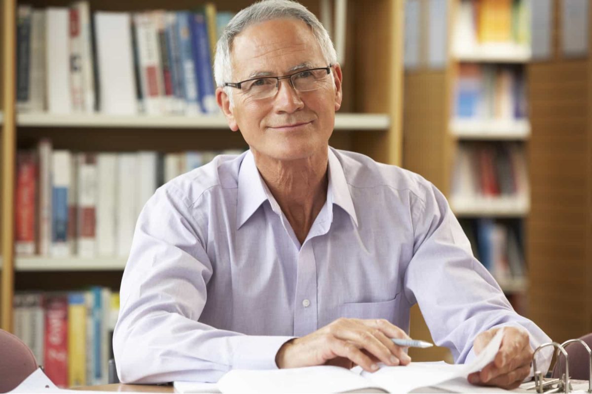 Smiling older male in library